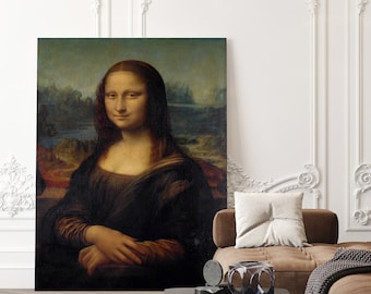 May include: A framed painting of the Mona Lisa, a famous portrait by Leonardo da Vinci, hangs on a white wall above a brown leather couch with a throw blanket and a coffee table with decorative objects.