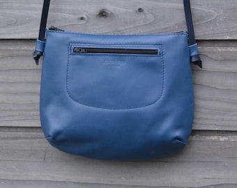 Small bag/clutch/handbag in soft blue leather with thin leather shoulder strap and zippers/zippers
