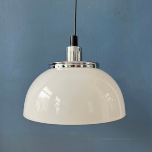 May include: A white dome-shaped pendant light fixture with a chrome finish and a black cord.