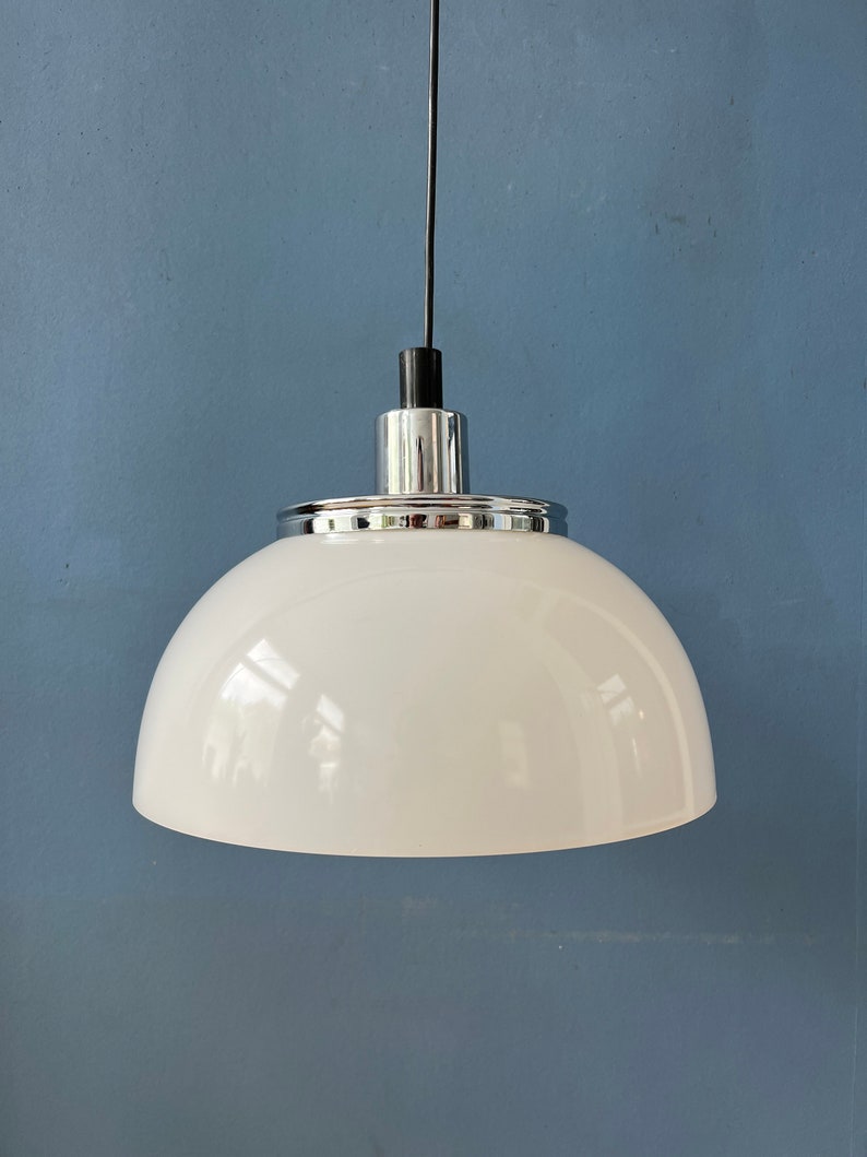 May include: A white dome-shaped pendant light fixture with a chrome finish and a black cord.