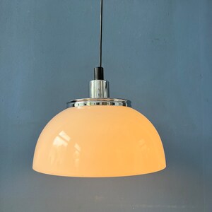 May include: A white dome-shaped pendant light fixture with a chrome finish and a black cord.