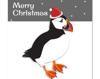 Puffin Christmas Card. Puffin in a santa hat. Puffin in snow.