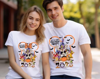 May include: White t-shirts with a colorful graphic featuring Disney characters, a castle, bats, and the text "NOT SO SCARY HALLOWEEN PARTY!" and "2025". The design includes Mickey and Minnie Mouse, and other characters.