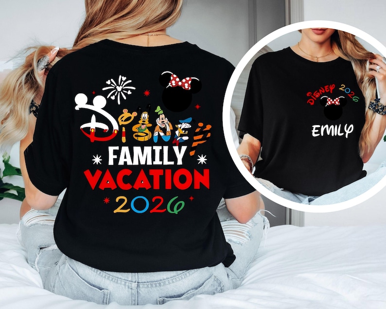 May include: Black t-shirt with a Disney Family Vacation 2026 design. The design includes the Disney logo, Mickey Mouse, Goofy, Donald Duck, and fireworks. A smaller image shows a black t-shirt with a Minnie Mouse design and the name "Emily".