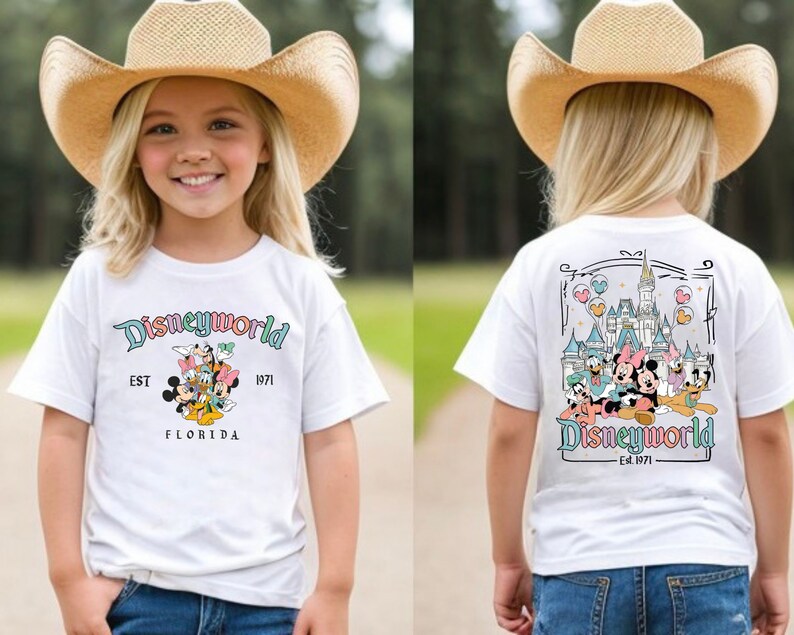 May include: White t-shirt with a colourful Disney World graphic on the front and back. The front features Mickey, Minnie, Donald, and Daisy Duck, with the text "Disneyworld EST 1971 FLORIDA". The back shows the Disney World castle and characters.