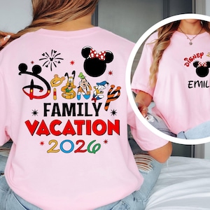 May include: A light pink t-shirt featuring a Disney Family Vacation design. The back of the shirt has a large graphic with the Disney logo, characters, and the words "Family Vacation 2026." The front of the shirt has a smaller design with a Minnie Mouse head and the name "EMILY."