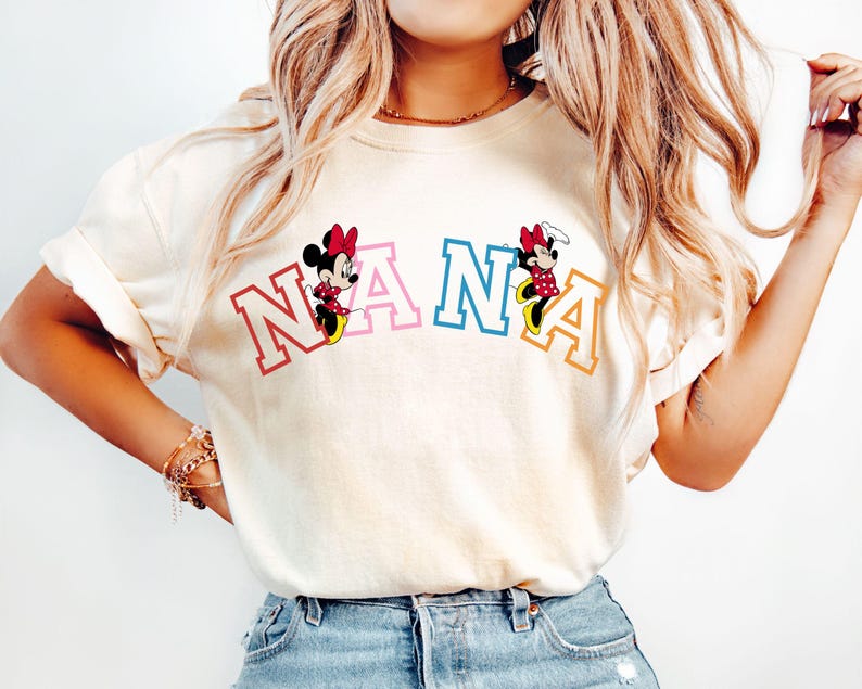 May include: A white t-shirt with the word "NANA" in colorful letters. Mickey Mouse and Minnie Mouse are on either side of the word.