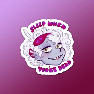 May include: A sticker with a cartoon character wearing a pink sleep mask and the text "Sleep when you're dead".