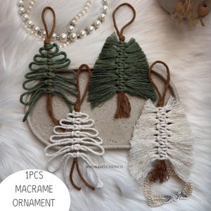 May include: Four macrame ornaments in tree and feather shapes, featuring green and off-white cord with brown hanging loops. The ornaments are arranged on a textured tray, with the text SUNSTITCHEDCO and 1PCS MACRAME ORNAMENT visible.