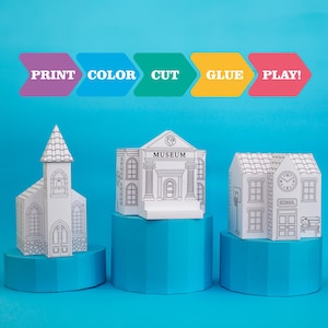 Puede incluir: Tres modelos de papel blanco de edificios: una iglesia, un museo y una escuela. El modelo del museo tiene la palabra "MUSEUM" impresa. El modelo de la escuela tiene una torre del reloj y la palabra "SCHOOL" impresa. Las instrucciones anteriores dicen "PRINT COLOR CUT GLUE PLAY!"