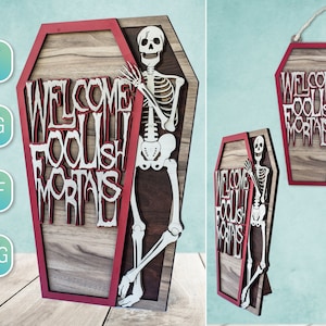 May include: Wooden coffin-shaped sign with the text "WELCOME FOOLISH MORTALS" and a skeleton. The sign has a red border and a wood grain background. A rope is attached for hanging. Ideal for Halloween.