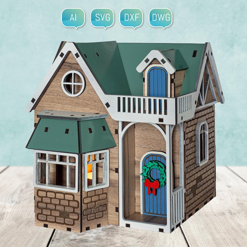 May include: A wooden model of a two-story house with a green roof, a blue door, and a wreath on the door. The house has a balcony on the second floor and a brick facade.