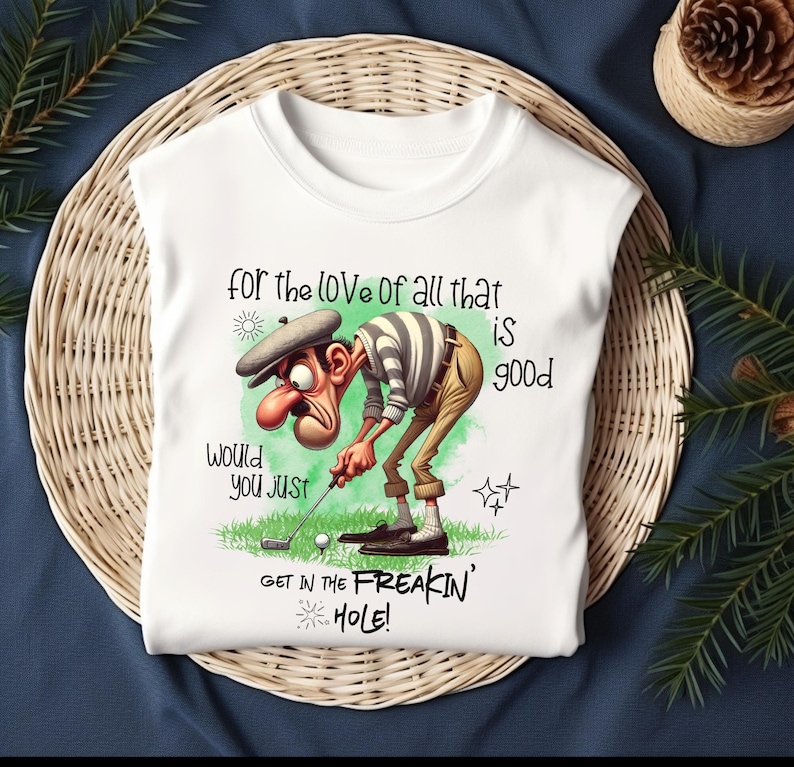 May include: White t-shirt with a cartoon golfer and the text "for the love of all that is good. Would you just get in the freakin' hole!"