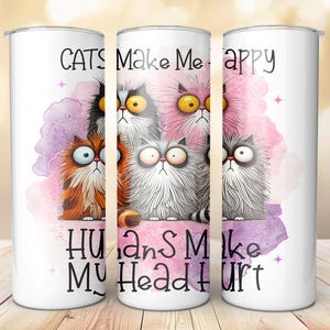 May include: White tumbler with a pink and purple watercolor background featuring cartoon cats with the text "Cats Make Me Happy Humans Make My Head Hurt".