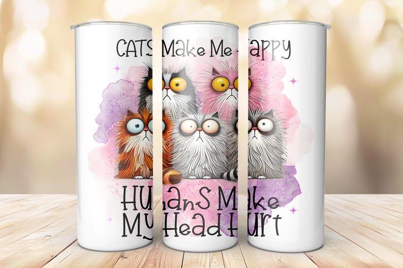 May include: White tumbler with a pink and purple watercolor background featuring cartoon cats with the text "Cats Make Me Happy Humans Make My Head Hurt".