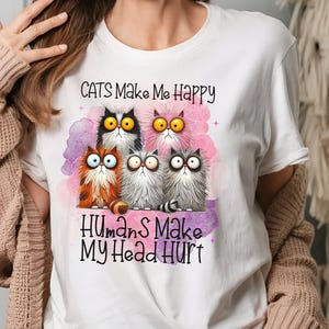 May include: White t-shirt with a graphic of four cartoon cats and the text "Cats Make Me Happy Humans Make My Head Hurt".