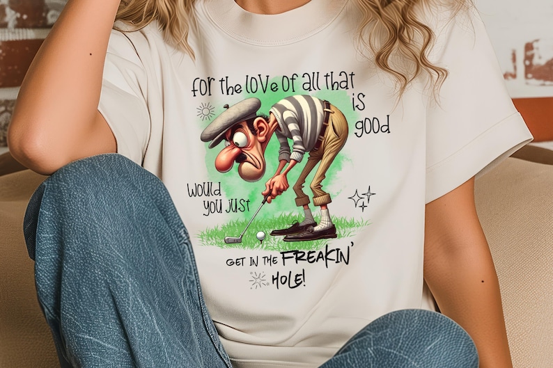 May include: White t-shirt with a cartoon golfer and the text "for the love of all that is good, would you just get in the freakin' hole!"