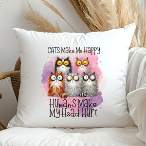 May include: White throw pillow with a colorful illustration of five cats and the text "Cats Make Me Happy Humans Make My Head Hurt".