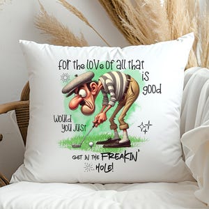 May include: White pillow with a cartoon golfer illustration and the text "for the love of all that is good, would you just get in the freakin' hole!"