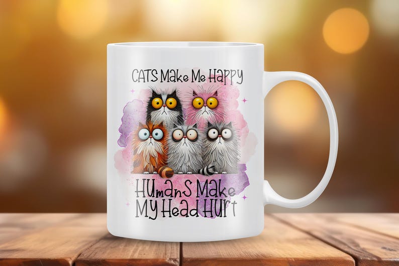 May include: White ceramic mug with a colorful illustration of five cats and the text "Cats Make Me Happy Humans Make My Head Hurt".