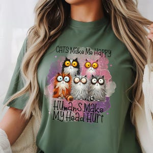 May include: Green t-shirt with a graphic of five cartoon cats and the text "Cats Make Me Happy Humans Make My Head Hurt".