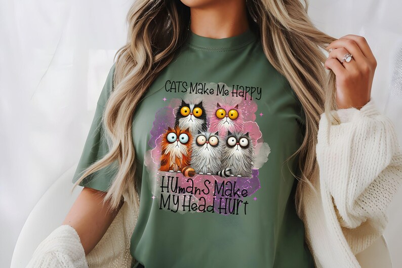 May include: Green t-shirt with a graphic of five cartoon cats and the text "Cats Make Me Happy Humans Make My Head Hurt".