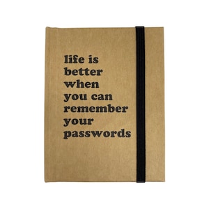 May include: A brown notebook with a black elastic closure. The notebook has the text "life is better when you can remember your passwords" printed on the front.