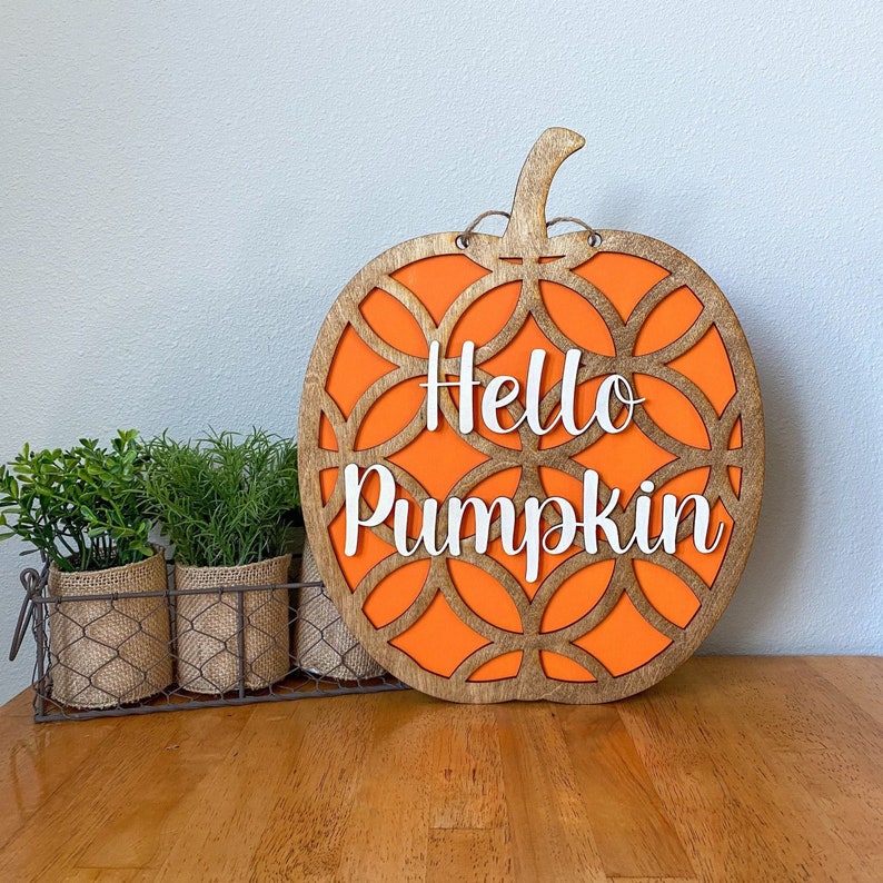 May include: Orange and brown wooden pumpkin cutout with the words 'Hello Pumpkin' in white lettering.