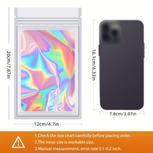 May include: A clear plastic bag with a holographic insert, measuring 20cm x 12cm (7.87in x 4.7in). A black phone is next to the bag, measuring 16.1cm x 7.8cm (6.33in x 3.07in). The bag has a zip closure. Text at the bottom advises to check the size chart.
