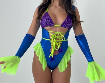 May include: A blue and purple bodysuit with a lace-up front and green trim. The bodysuit has a ruffled skirt and is paired with matching blue and green arm warmers.