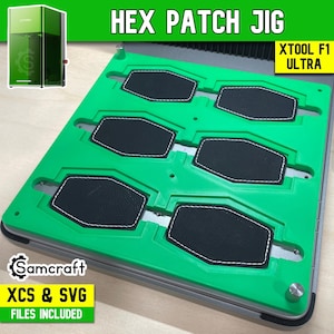May include: A bright green hex patch jig for the xTool F1 Ultra laser machine. The jig features six hexagonal cutouts holding black leather patches with white stitching. Text on the image includes HEX PATCH JIG, XTOOL F1 ULTRA, and Samcraft XCS & SVG FILES INCLUDED.
