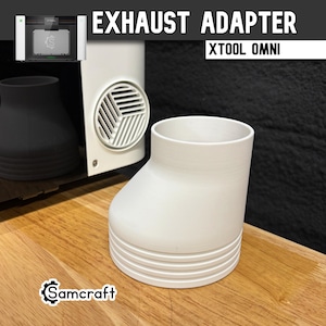 May include: A white, cylindrical exhaust adapter for the xTool Omni, featuring a stepped base design. The text EXHAUST ADAPTER and XTOOL OMNI appear at the top, with a Samcraft logo in the corner. The adapter has a smooth, tapered upper section.