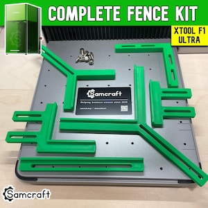 May include: A complete fence kit for the xTool F1 Ultra, featuring several green plastic L-shaped and straight slotted alignment guides, a small collection of metal screws, and a black Samcraft information card on a gray metal base plate.
