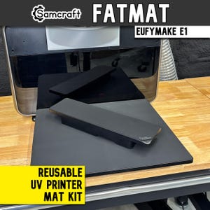 May include: A Samcraft Fatmat Eufymake E1 reusable UV printer mat kit featuring a large black rectangular mat and two smaller black rectangular blocks. The text Samcraft Fatmat Eufymake E1 and Reusable UV Printer Mat Kit is visible.