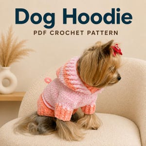 May include: A small dog wearing a pink and orange ombre crochet hoodie with a hood and a small loop on the back. The text Dog Hoodie PDF CROCHET PATTERN is displayed at the top. The dog has long tan fur and a small red bow on its head.