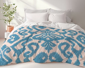 May include: A teal and cream patterned duvet cover with a modern geometric design. The duvet cover is made of soft, breathable fabric and is perfect for adding a touch of style to any bedroom.
