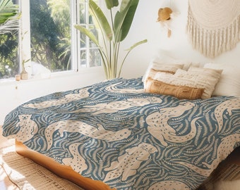 May include: A blue and cream duvet cover with a repeating pattern of otters swimming in a field of ferns. The duvet cover is on a bed with a wooden frame and a tan rug.