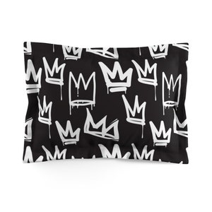 May include: Black pillowcase with a white crown pattern. The crowns are drawn in a graffiti style with drips.