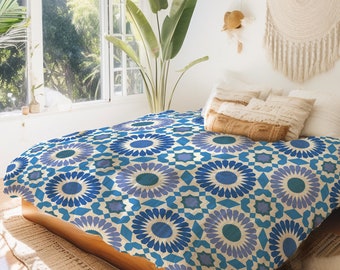 May include: A blue and white patterned duvet cover with a geometric design. The duvet cover is on a bed with white pillows and a brown throw pillow.