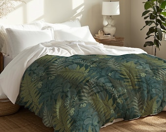 May include: A white duvet cover with a green and brown fern pattern. The duvet cover is on a bed with white pillows and a wooden nightstand with a lamp.