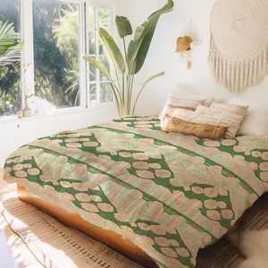 May include: A green and beige patterned duvet cover with a floral design. The duvet cover is on a bed with white and beige pillows.