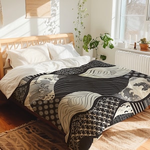 May include: Black and white patterned duvet cover with a geometric design. The duvet cover is on a bed with white pillows and a wooden headboard.