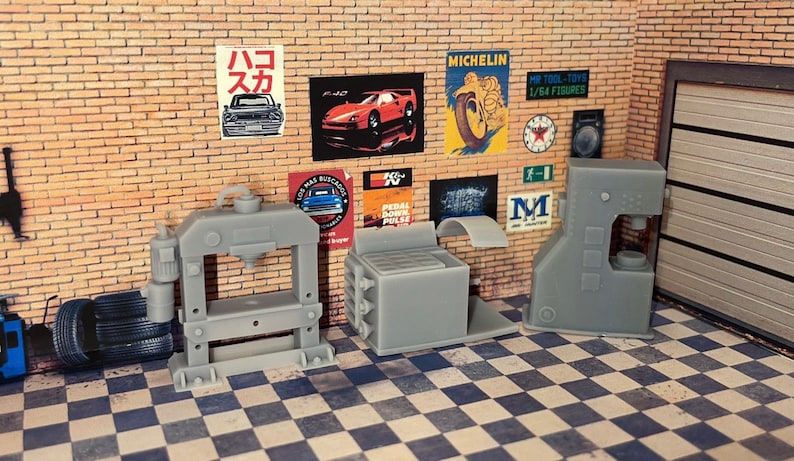 May include: Three gray metal shop presses, including a large press with a foot pedal, a smaller press with a lever, and a press with a handle. The presses are on a checkered black and white floor.