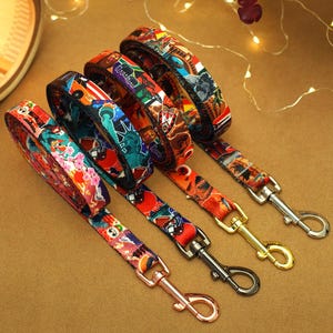 May include: Five colorful dog leashes with different patterns and designs. Each leash has a metal clip at the end.