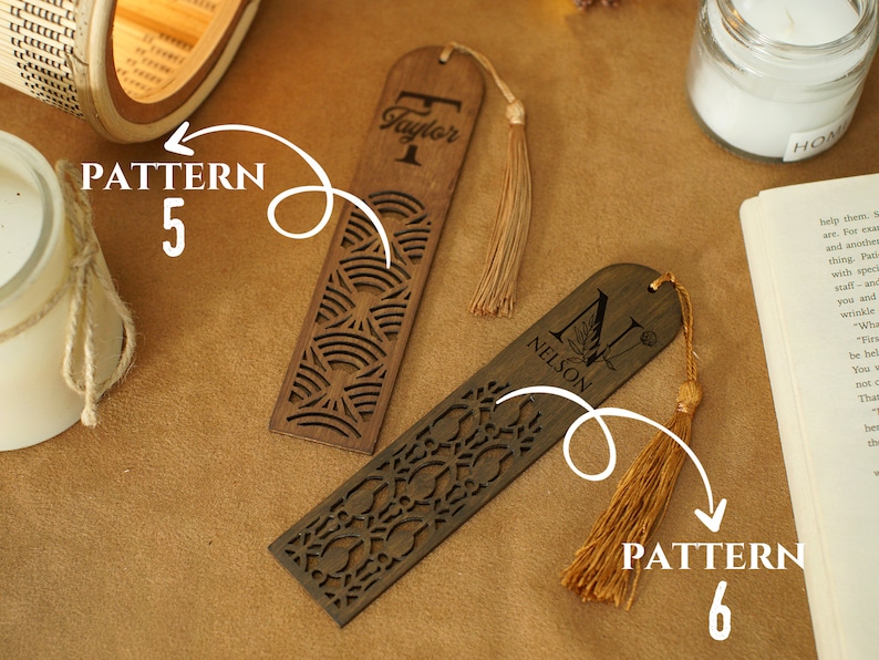 May include: Two wooden bookmarks with personalized names, "Taylor" and "Nelson", and decorative patterns. The bookmarks have tassels attached.