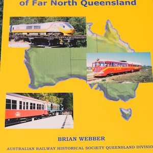 May include: A book cover with a yellow background and the title "Exploring the Railways of Far North Queensland". The cover features three photos of trains, including a red and white train, a yellow and red train, and a red train with a white roof.