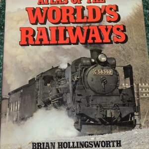 May include: A vintage book cover featuring a black steam locomotive with the text "Atlas of the World's Railways" and the author's name "Brian Hollingsworth".