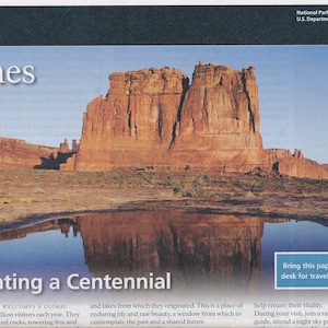 May include: A visitor guide for Arches National Park, celebrating the National Park Service Centenary in 2016. The guide features a photo of a large red rock formation reflected in a still body of water. The text "Arches" is in large letters at the top of the page, and the text "Celebrating a Centennial" is in large letters at the bottom of the page.