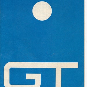 Op de afbeelding: Een blauwe en rode dienstregeling voor de Grand Trunk Western Railroad, gedateerd 1 juli 1967. De omslag heeft een gestileerd "GT"-logo en een witte cirkel.