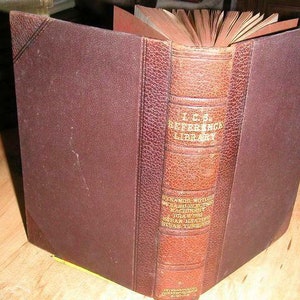 May include: A brown leather-bound book with the title "I.C.S. Reference Library" on the spine. The book is open and the pages are visible. The book is about "Steam Boilers, Engines, Motors, and Machinery, with Drawings and Descriptions of Steam Engines, Steam Turbines, etc."